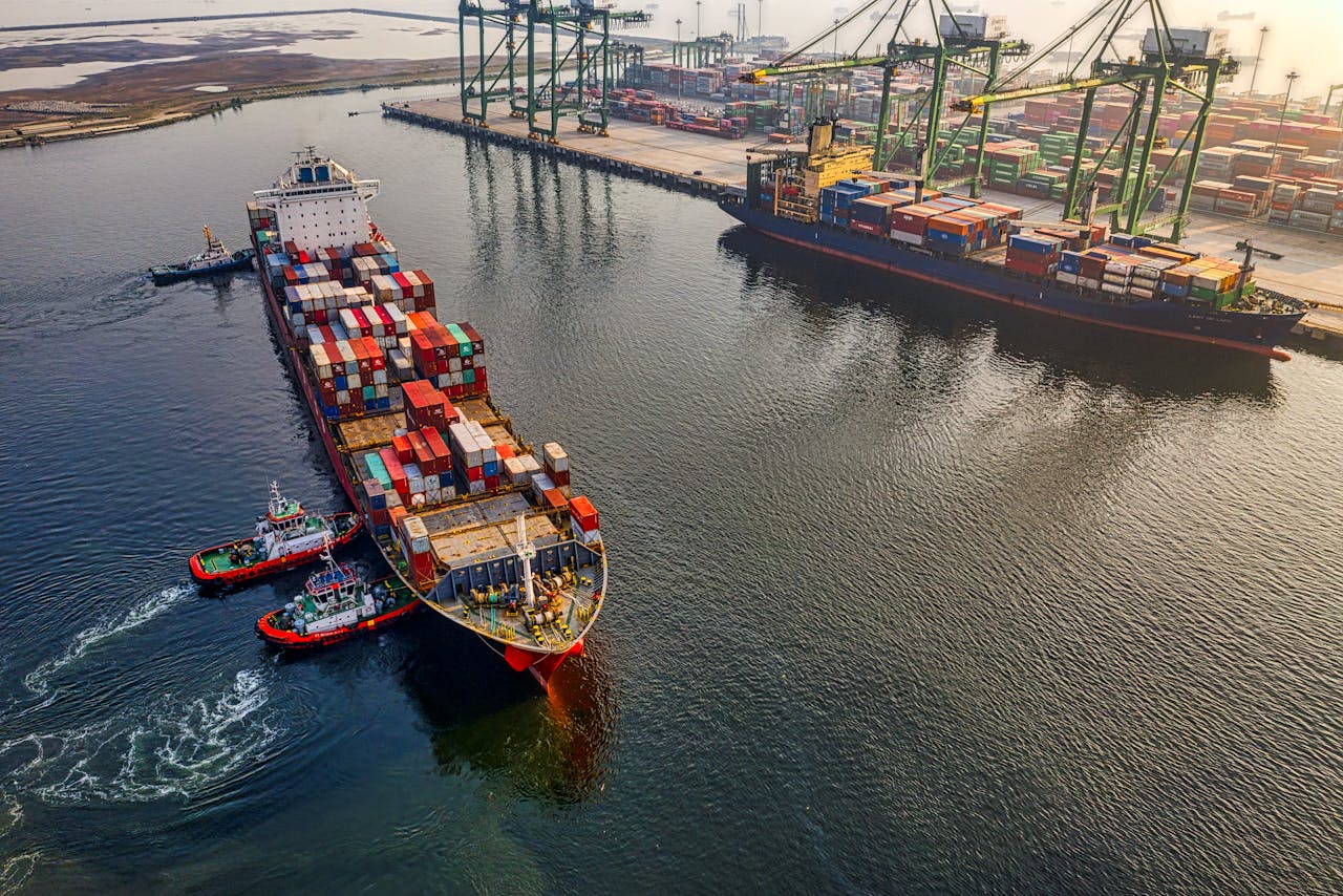 our-story Aerial shot of cargo ships and cranes at North Jakarta port, showcasing global shipping and logistics.